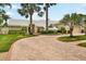 A stunning one-story home featuring a white tile roof and a circular brick driveway at 4138 Saltwater Blvd, Tampa, FL 33615