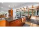 Bright eat-in kitchen with island, granite counters, hardwood floors, and views of the pool at 4138 Saltwater Blvd, Tampa, FL 33615