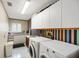 Practical laundry room with cabinets, sink, and appliances, enhanced by colorful wall accents at 4138 Saltwater Blvd, Tampa, FL 33615