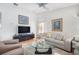 Enjoy this living area, featuring hardwood floors, a ceiling fan, and ample natural light at 4138 Saltwater Blvd, Tampa, FL 33615