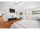 The primary bedroom has hardwood floors, a ceiling fan, and built in storage space and shelving at 4138 Saltwater Blvd, Tampa, FL 33615
