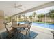 Relaxing screened patio with a dining set overlooking the sparkling pool and landscaped backyard at 4138 Saltwater Blvd, Tampa, FL 33615