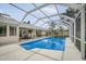 Screened pool with clear blue water, surrounding patio with dining and lounging, with access to the home at 4138 Saltwater Blvd, Tampa, FL 33615