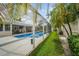 Enjoy the Florida lifestyle with this inviting screened-in pool and lush landscaping at 4138 Saltwater Blvd, Tampa, FL 33615