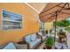 Cozy balcony featuring an umbrella, seating, and decorative plants for relaxing outdoors at 456 Bayou Village Dr, Tarpon Springs, FL 34689