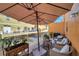 Relaxing balcony with cozy chairs, umbrella, and decor for outdoor comfort and style at 456 Bayou Village Dr, Tarpon Springs, FL 34689
