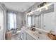 Bright bathroom featuring a double sink vanity, elegant lighting, and stylish details at 456 Bayou Village Dr, Tarpon Springs, FL 34689