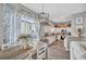 Open kitchen and dining area with white cabinetry, stainless appliances, and modern decor at 456 Bayou Village Dr, Tarpon Springs, FL 34689