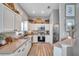 Well-lit kitchen with white cabinets, stainless steel appliances, and stylish decor at 456 Bayou Village Dr, Tarpon Springs, FL 34689