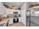 Modern kitchen with white cabinets, stainless steel appliances, and a breakfast bar at 456 Bayou Village Dr, Tarpon Springs, FL 34689