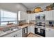 Well-equipped kitchen with white cabinets, stainless steel appliances, and abundant counter space at 456 Bayou Village Dr, Tarpon Springs, FL 34689