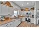 Bright kitchen featuring white cabinets, stainless steel appliances, and neutral countertops at 456 Bayou Village Dr, Tarpon Springs, FL 34689