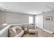 Neutral living room with comfortable seating, soft rug, and plenty of natural light at 456 Bayou Village Dr, Tarpon Springs, FL 34689