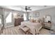 Airy main bedroom with plush bedding, stylish furnishings, and plenty of natural light at 456 Bayou Village Dr, Tarpon Springs, FL 34689