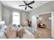 Comfortable main bedroom with modern ceiling fan, large window, and an attached sitting area at 456 Bayou Village Dr, Tarpon Springs, FL 34689