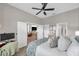 Spacious main bedroom featuring a ceiling fan, ensuite, and comfortable bedroom furniture at 456 Bayou Village Dr, Tarpon Springs, FL 34689