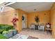 Inviting front porch with cozy seating, decorative plants, and a welcoming wreath on the front door at 456 Bayou Village Dr, Tarpon Springs, FL 34689