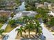 Aerial view of a blue home with a gray roof, surrounded by lush greenery and waterfront access at 4643 Bay Crest Dr, Tampa, FL 33615