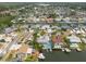 Aerial view of canal-front homes in a residential neighborhood; blue home with pool, docks, and boat access at 4643 Bay Crest Dr, Tampa, FL 33615
