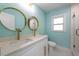 Bathroom featuring dual sinks with gold fixtures and a glass door shower at 4643 Bay Crest Dr, Tampa, FL 33615