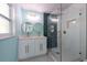 Bathroom with walk-in shower, dual sinks, and blue accent wall at 4643 Bay Crest Dr, Tampa, FL 33615