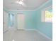 Bright bedroom featuring cool aqua walls, a ceiling fan, and light tile floors at 4643 Bay Crest Dr, Tampa, FL 33615