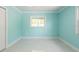 Bright bedroom featuring cool aqua walls, a ceiling fan, and light tile floors at 4643 Bay Crest Dr, Tampa, FL 33615