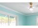 Bright bedroom featuring cool aqua walls and a ceiling fan at 4643 Bay Crest Dr, Tampa, FL 33615