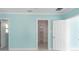 Bright bedroom with an open closet, large doors, and light-blue walls at 4643 Bay Crest Dr, Tampa, FL 33615