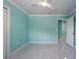 Bright bedroom featuring cool aqua walls, a ceiling fan, and light tile floors at 4643 Bay Crest Dr, Tampa, FL 33615