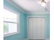 Bedroom featuring a window and double closet doors at 4643 Bay Crest Dr, Tampa, FL 33615