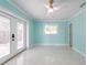 Light-filled bedroom with a ceiling fan, white trim, and access to the outdoors at 4643 Bay Crest Dr, Tampa, FL 33615