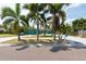 Lovely blue home with lush palm trees, a well-kept lawn, and decorative signage, set in a sunny locale at 4643 Bay Crest Dr, Tampa, FL 33615