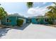 Beautifully landscaped single-story home with a blue exterior and a spacious driveway at 4643 Bay Crest Dr, Tampa, FL 33615