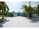 Charming single-story home featuring a two-car garage, large driveway, and lush landscaping at 4643 Bay Crest Dr, Tampa, FL 33615