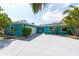 Charming single-story home featuring a two-car garage, large driveway, and lush landscaping at 4643 Bay Crest Dr, Tampa, FL 33615