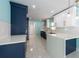 Galley kitchen with white and navy cabinets, recessed lighting, and stainless steel appliances at 4643 Bay Crest Dr, Tampa, FL 33615