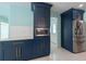 Galley kitchen featuring stainless steel appliances, navy cabinets, and white subway tile backsplash at 4643 Bay Crest Dr, Tampa, FL 33615
