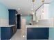 Bright galley kitchen with white subway tile, navy blue cabinets, and gold hardware accents at 4643 Bay Crest Dr, Tampa, FL 33615