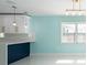 Eat-in kitchen featuring shaker cabinets, modern lighting, and bright natural light at 4643 Bay Crest Dr, Tampa, FL 33615
