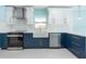 Stylish kitchen featuring shaker cabinets, stainless steel appliances, and bright natural light at 4643 Bay Crest Dr, Tampa, FL 33615