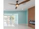 A spacious living room with tile floors, a modern ceiling fan, and a fireplace at 4643 Bay Crest Dr, Tampa, FL 33615