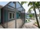 Relaxing screened patio area features a hammock, vibrant landscaping, and double door access at 4643 Bay Crest Dr, Tampa, FL 33615