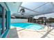 Enjoy the serene screened-in pool overlooking the canal, perfect for unwinding and enjoying the waterfront view at 4643 Bay Crest Dr, Tampa, FL 33615