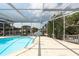 Lovely screened-in pool and patio area offer tranquil waterfront views, perfect for enjoying outdoor living and entertaining at 4643 Bay Crest Dr, Tampa, FL 33615