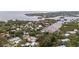 An aerial view of a neighborhood with lush tree coverage, and waterfront access at 608 Betmor Ln, Palm Harbor, FL 34683