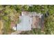 Aerial view of home showing roof, backyard, driveway, and surrounding trees at 608 Betmor Ln, Palm Harbor, FL 34683