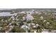 Waterfront neighborhood featuring a river winding past a mix of quaint houses and tropical vegetation at 608 Betmor Ln, Palm Harbor, FL 34683