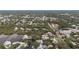Aerial view of waterfront homes surrounded by mature trees and lush landscapes along the water at 608 Betmor Ln, Palm Harbor, FL 34683