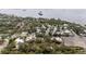 A picturesque aerial view of homes nestled amongst trees near waterways and Tampa Bay at 608 Betmor Ln, Palm Harbor, FL 34683